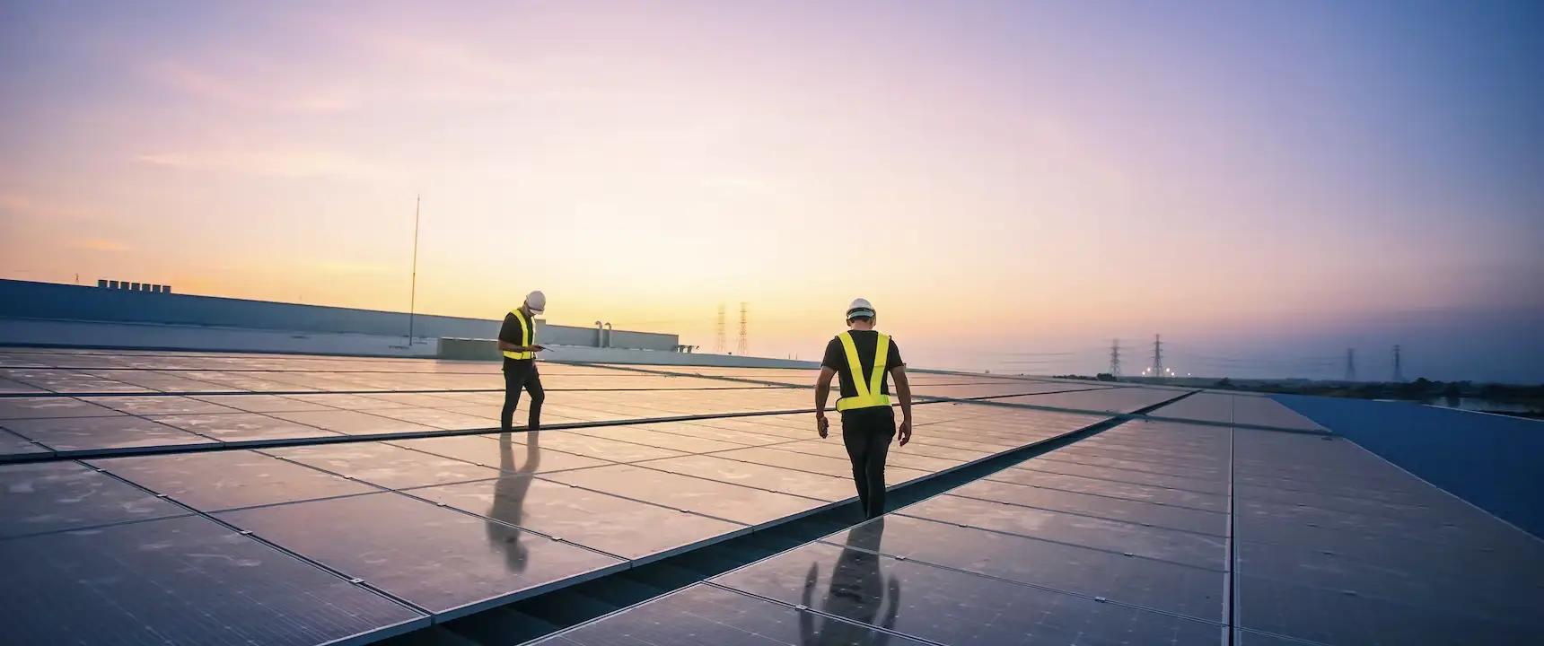 two safety officers inspecting the roof mounted solar systems