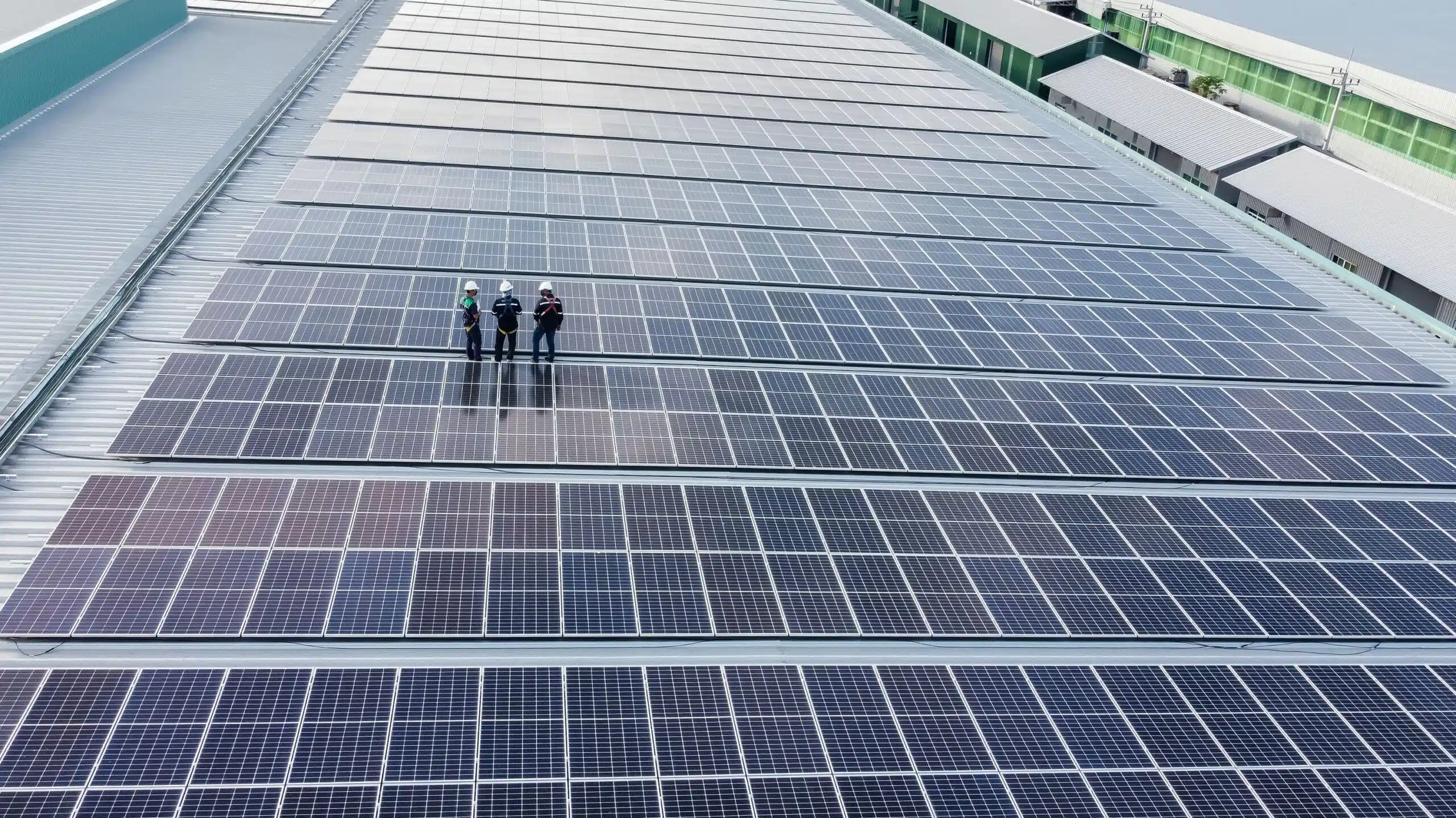 solar panel professionals standing on a solar panel grid