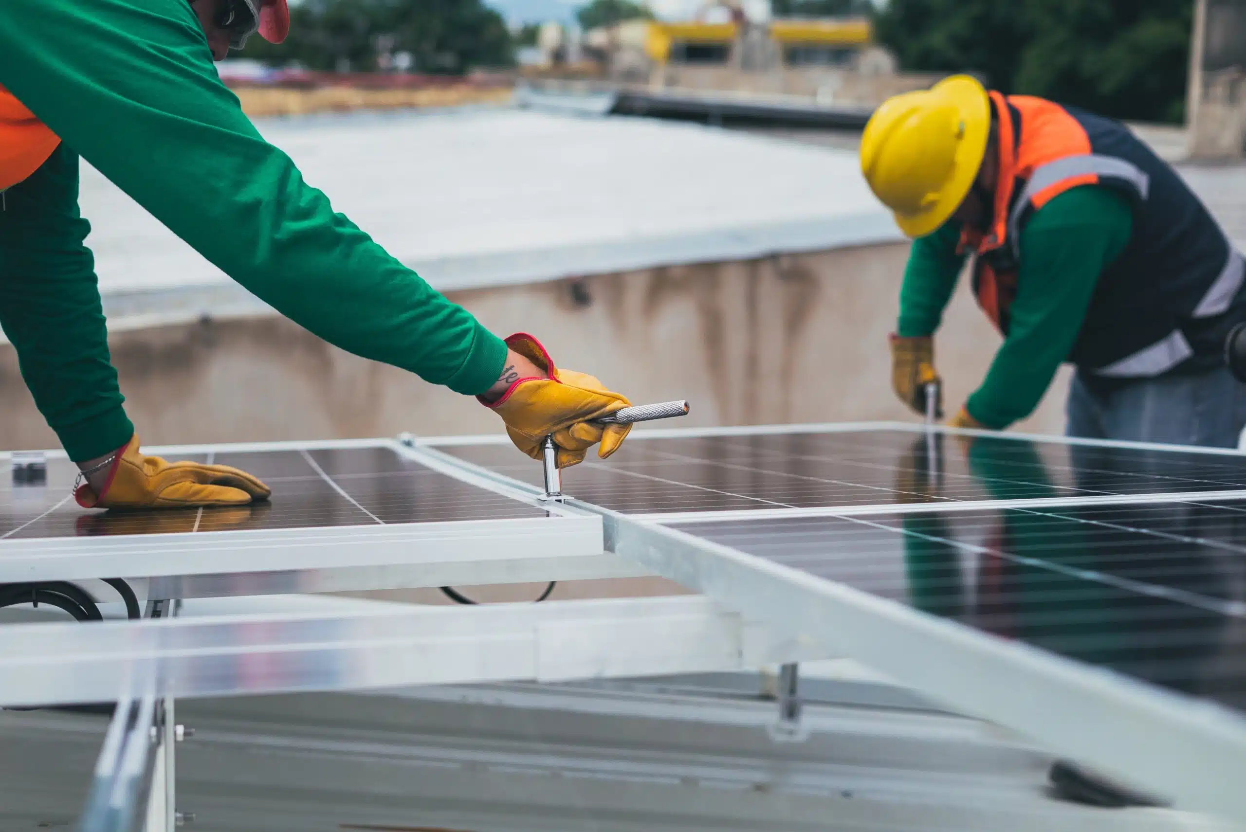 two solar panel installers installing a solar roof