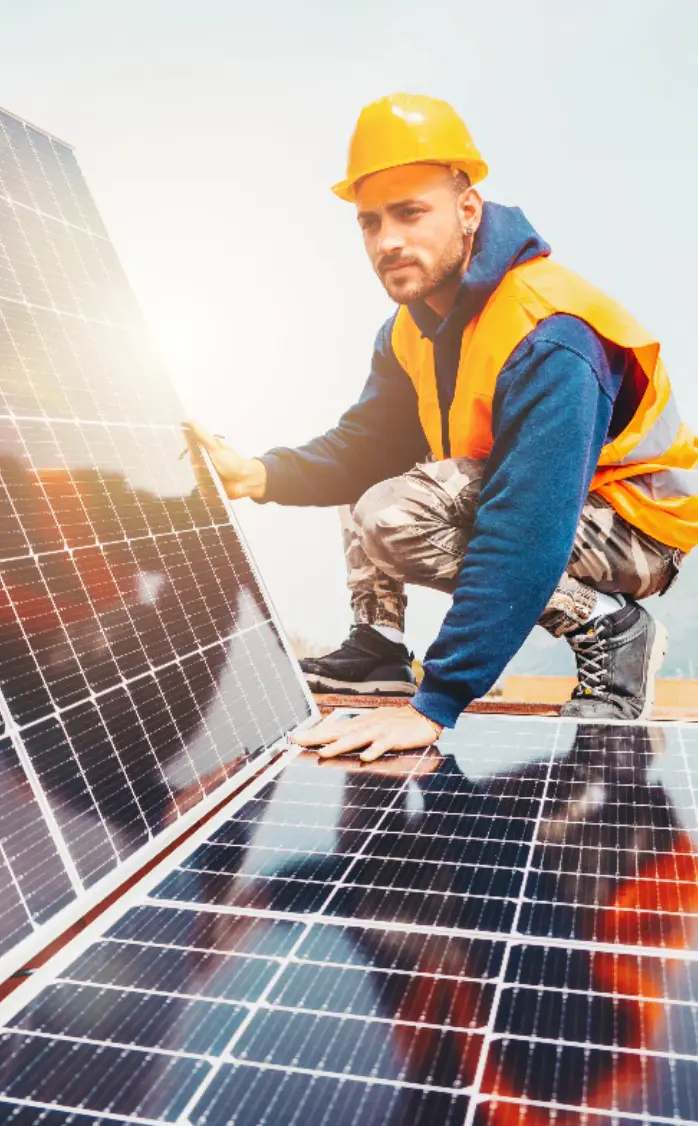 A man installing a solar panel