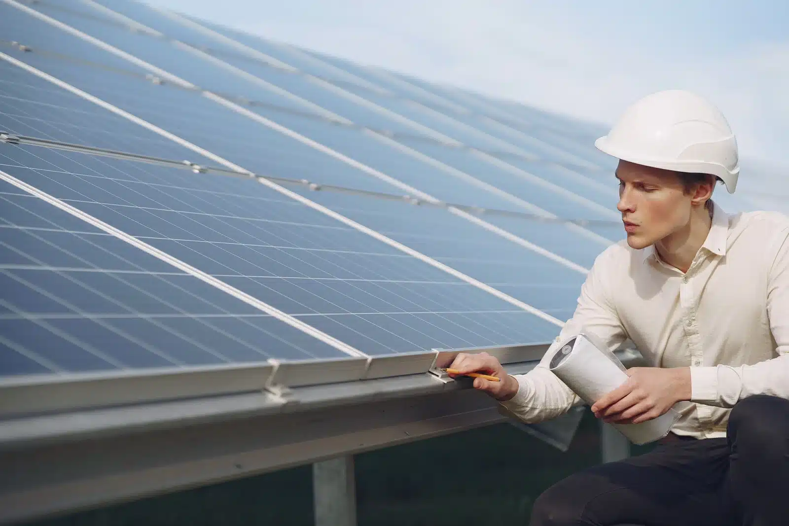 a person inspecting the solar panel