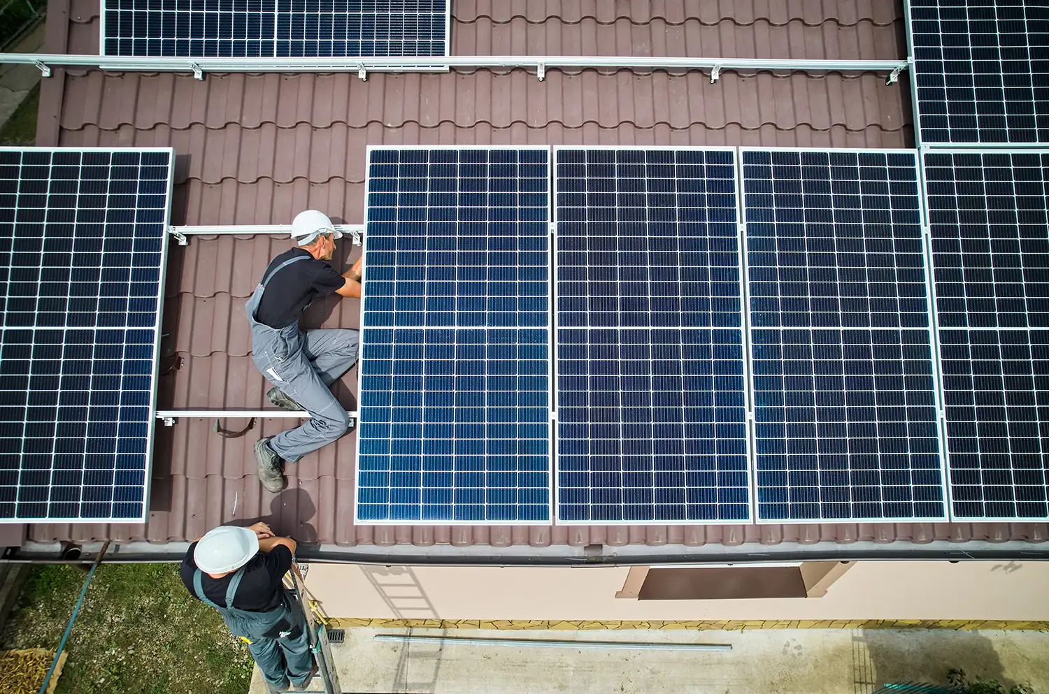 two person installing roof mounted solar systems